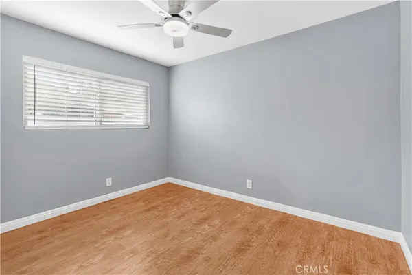 a view of an empty room with a ceiling fan
