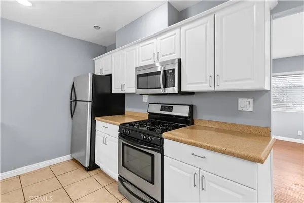 a bathroom with a granite countertop sink a large mirror and a shower