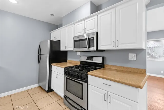 a bathroom with a granite countertop sink a large mirror and a shower