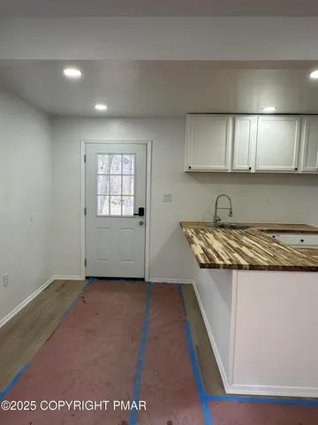an empty room with wooden floor and window