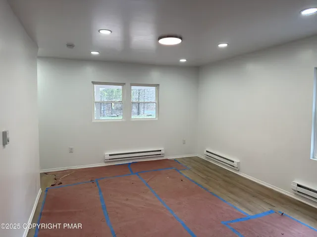 an empty room with wooden floor and closet