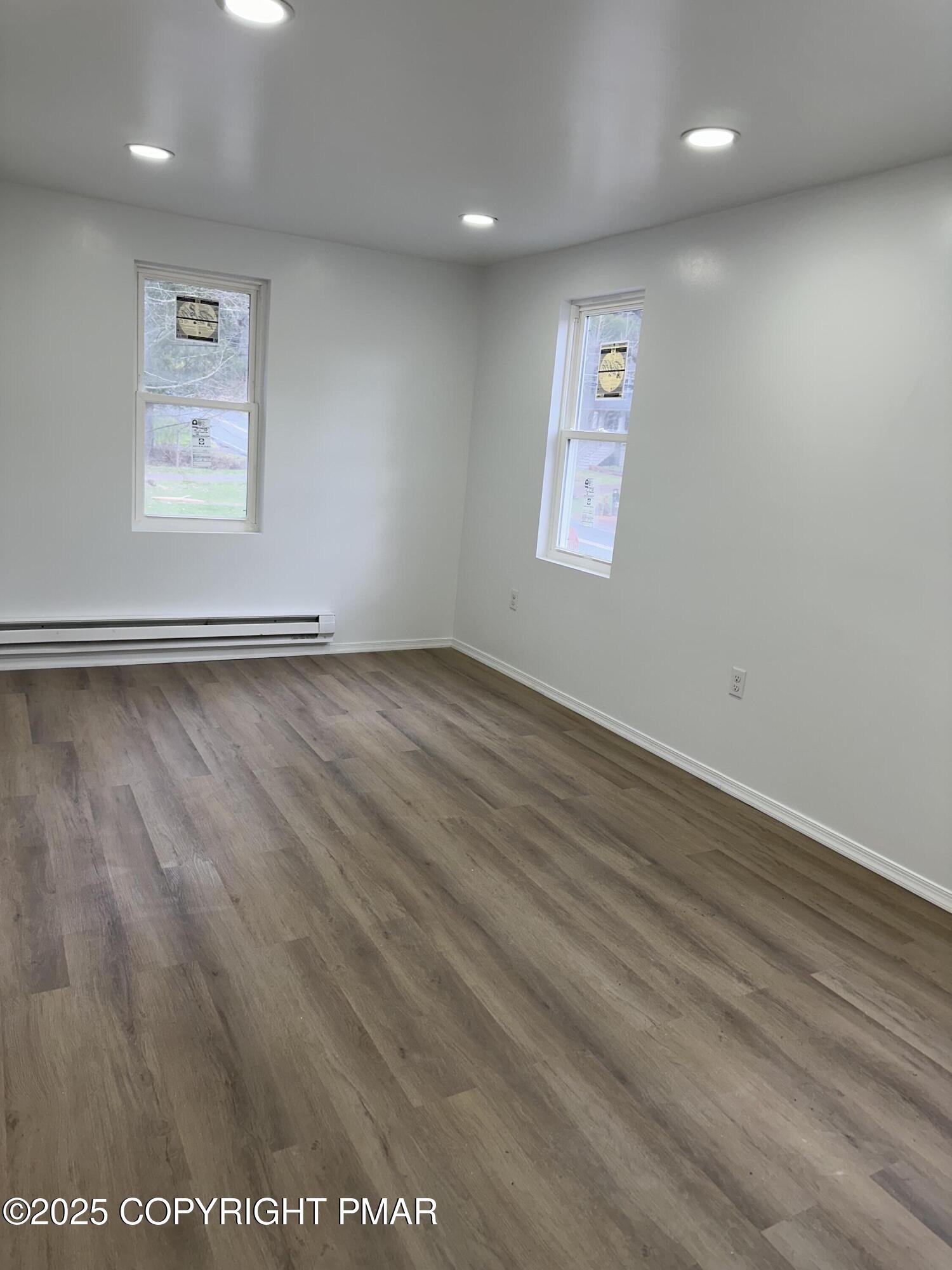 105 Glenmere Road Canadensis, PA 18325 - Photo 15 of 28 an empty room with wooden floor and windows