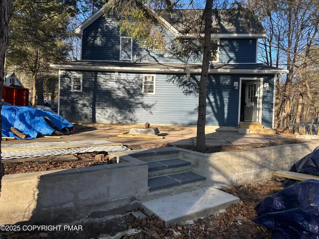 an empty room with wooden floor and ceiling fan