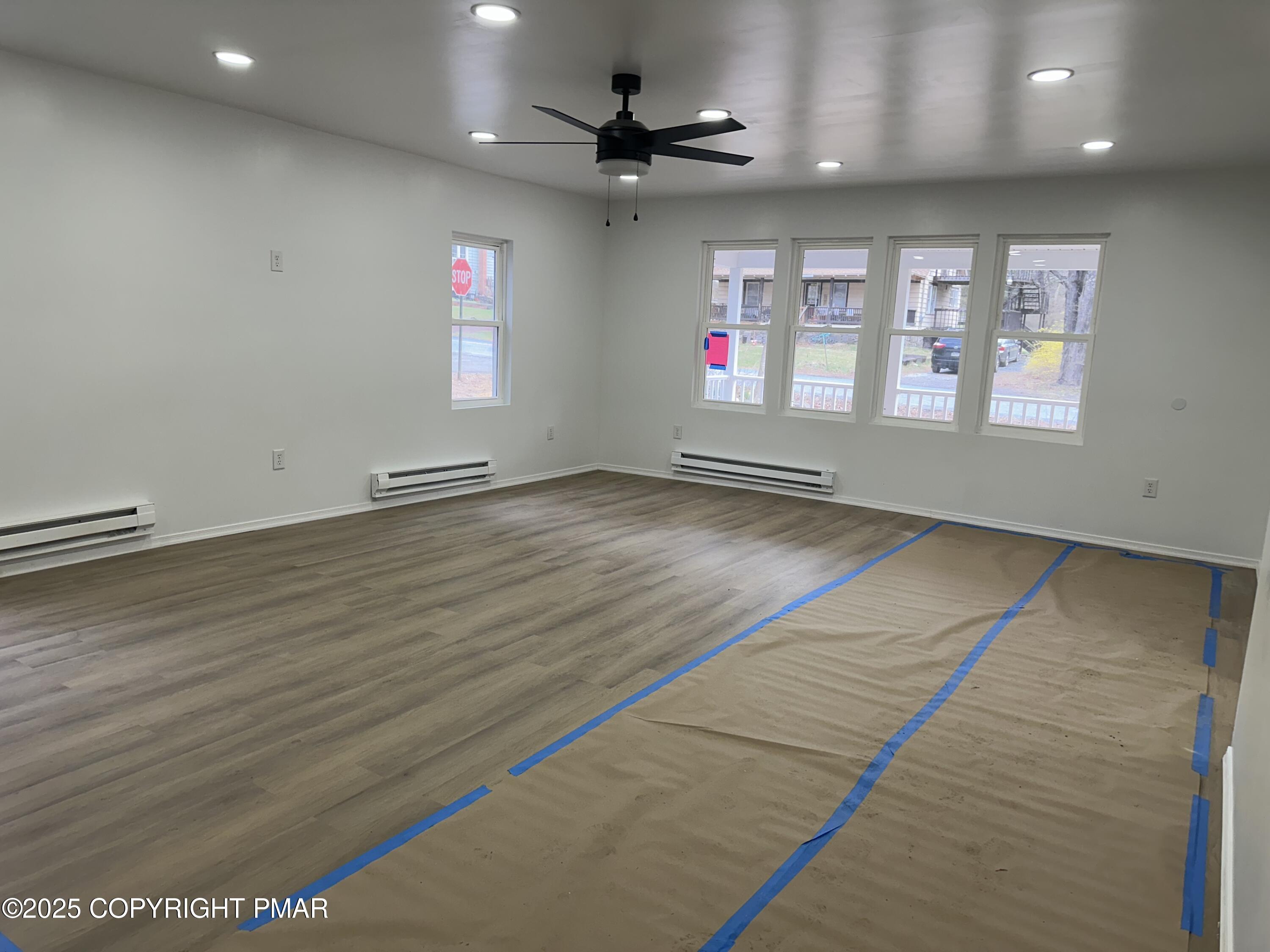 105 Glenmere Road Canadensis, PA 18325 - Photo 5 of 28 an empty room with wooden floor and ceiling fan