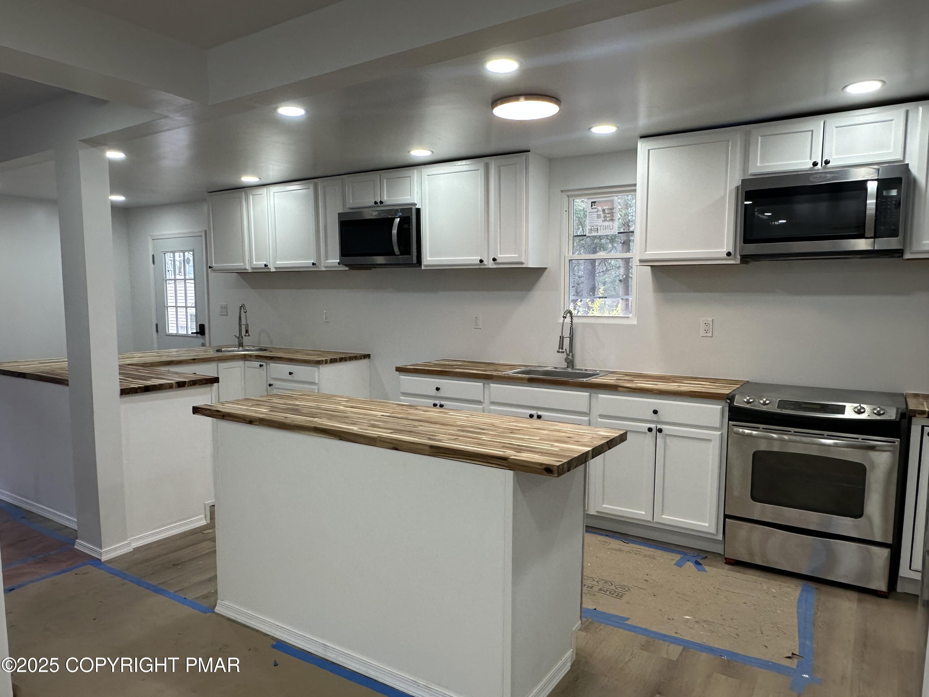 105 Glenmere Road Canadensis, PA 18325 - Photo 8 of 28 a kitchen with stainless steel appliances granite countertop a sink and a stove