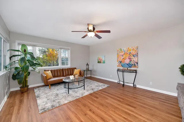 a living room with furniture a flat screen tv and a fireplace