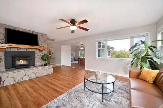a kitchen with stainless steel appliances granite countertop a sink a stove and refrigerator