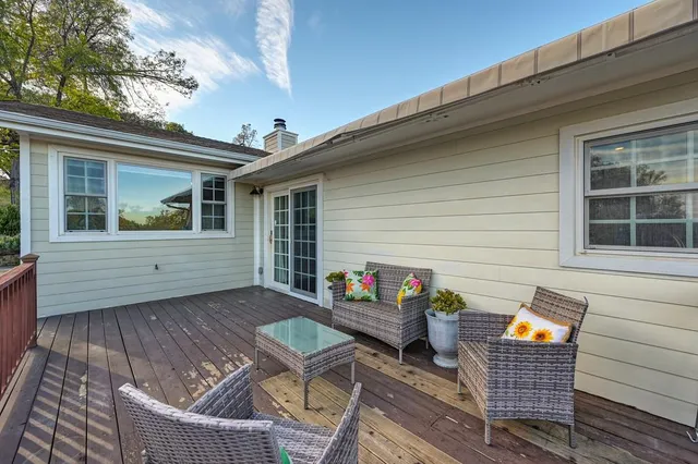 a view of a house with backyard and sitting area