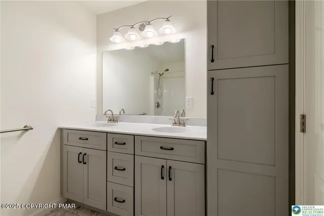 a bathroom with a double vanity sink and mirror