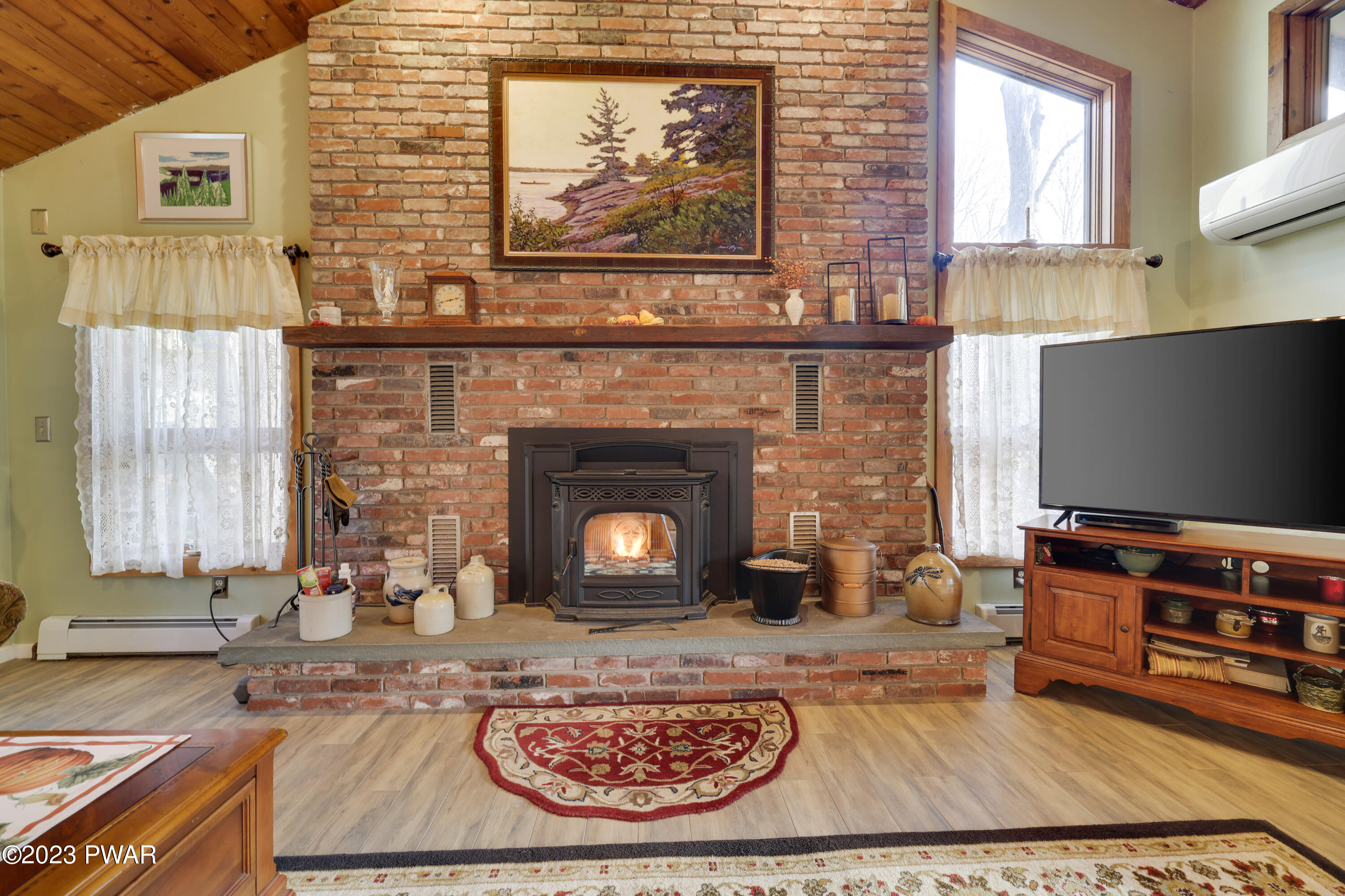 6348 Decker Road Bushkill, PA 18324 - Photo 4 of 36 a living room with furniture a flat screen tv and a fireplace