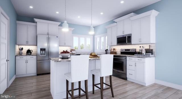 Lot#2 Exeter Road Ocean City, MD 21842 - Photo 7 of 27 a kitchen with kitchen island granite countertop a sink cabinets and wooden floor