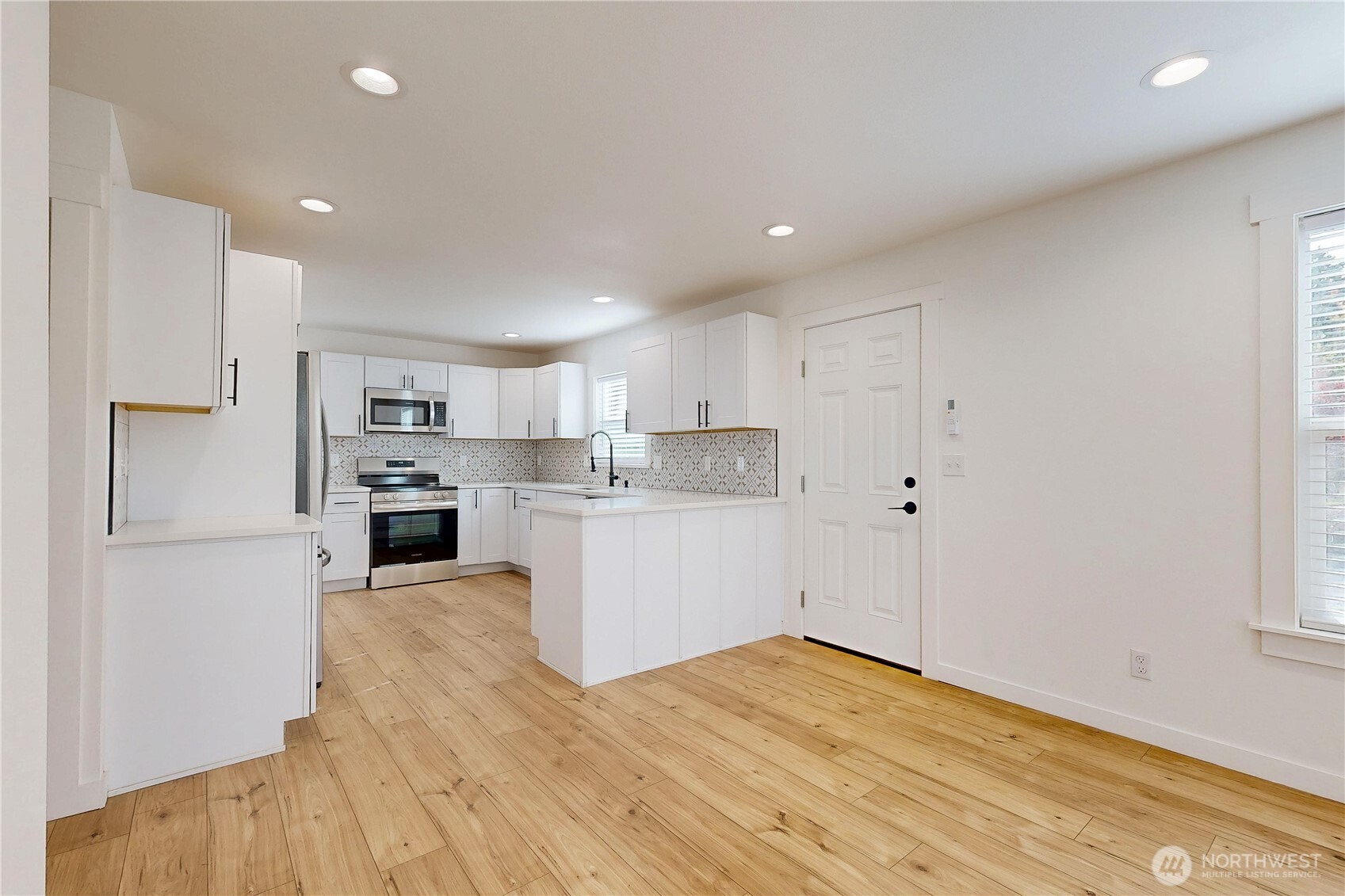 995 Hobson Street Walla Walla, WA 99362 - Photo 7 of 38 a kitchen with white cabinets and stainless steel appliances