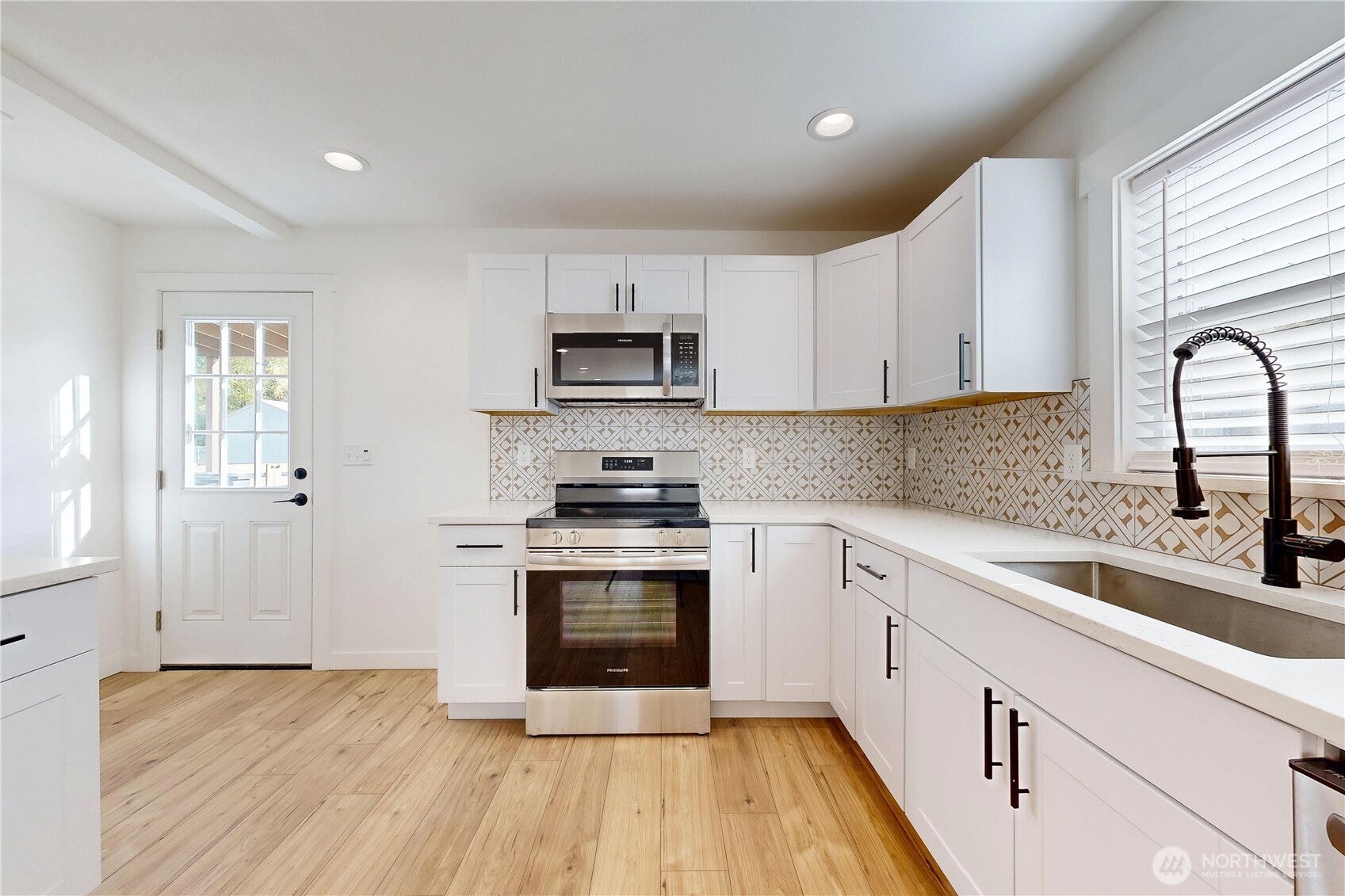 995 Hobson Street Walla Walla, WA 99362 - Photo 10 of 38 a kitchen with stainless steel appliances granite countertop a stove a sink dishwasher and a refrigerator with wooden floor