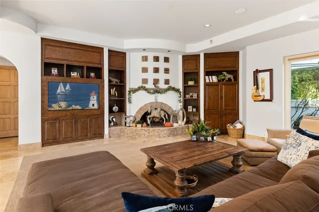 a view of kitchen island with stainless steel appliances granite countertop a sink a stove and a refrigerator