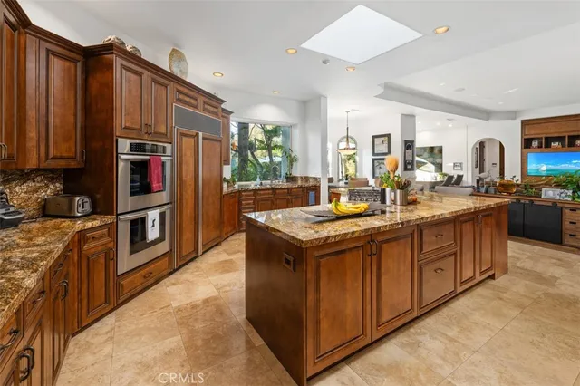 a living room with furniture a ceiling fan and a large window