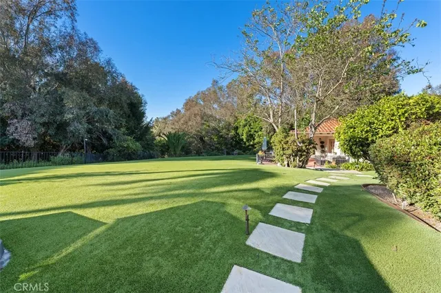 a aerial view of a house with swimming pool a yard and mountain view in back yard