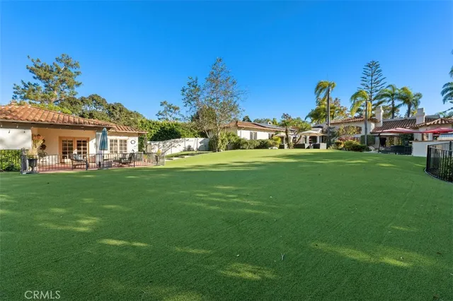 an aerial view of residential house with yard and ocean view