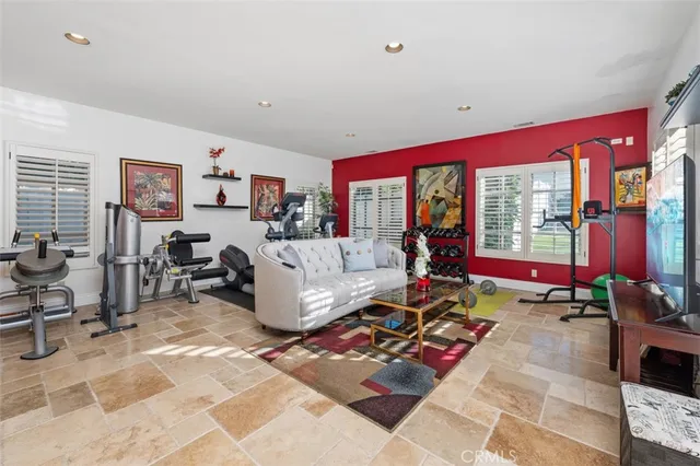 a view of a house with a yard and palm trees
