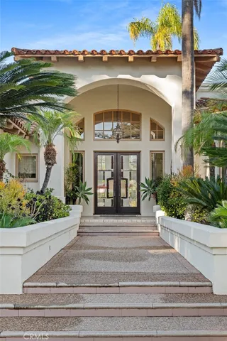 a living room with furniture pool table kitchen view and a fireplace