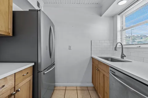 a kitchen with a sink and refrigerator