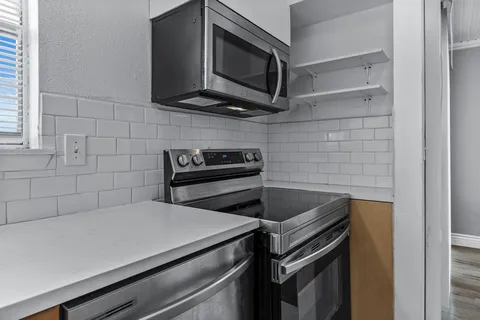 a kitchen with a stove and a microwave