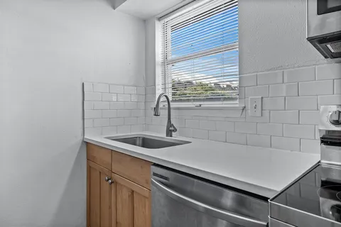 a kitchen with a sink and cabinets