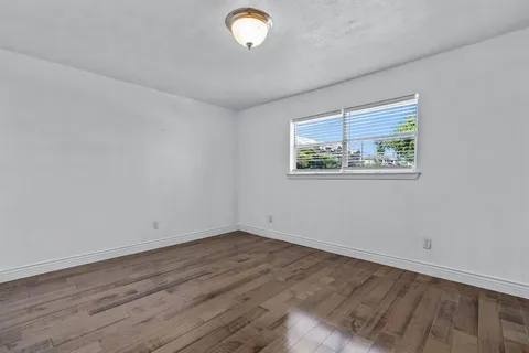 a view of room with wooden floor and window