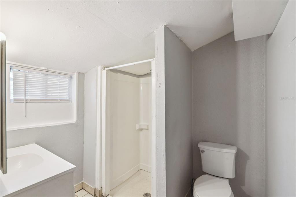 113 South Grove Street, Unit 2 Eustis, FL 32726 - Photo 13 of 15 a white toilet sitting next to a bathroom sink