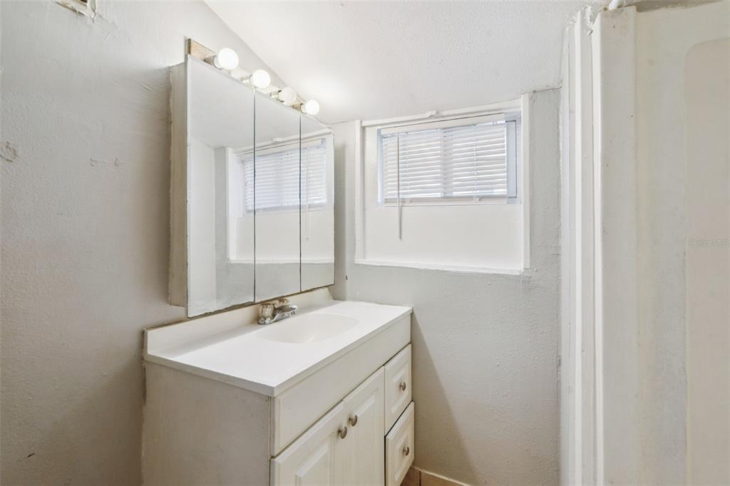 113 South Grove Street, Unit 2 Eustis, FL 32726 - Photo 14 of 15 a bathroom with a sink and a mirror
