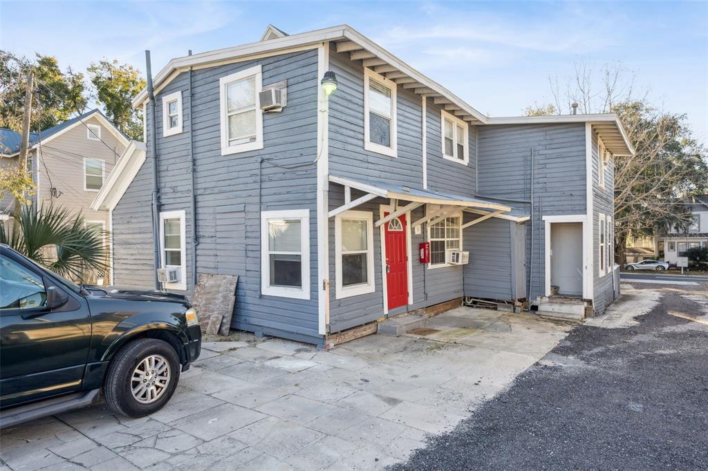 113 South Grove Street, Unit 2 Eustis, FL 32726 - Photo 15 of 15 a front view of a house with parking space