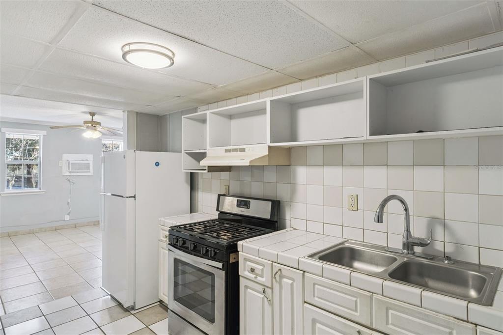 113 South Grove Street, Unit 2 Eustis, FL 32726 - Photo 7 of 15 a kitchen with a sink stove and refrigerator