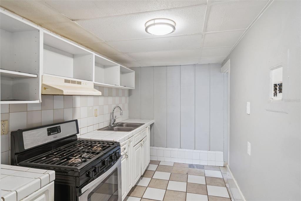 113 South Grove Street, Unit 2 Eustis, FL 32726 - Photo 8 of 15 a kitchen that has a sink and a stove