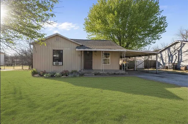 a front view of house with yard and green space
