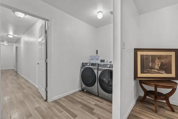 a view of a hallway with washer and dryer