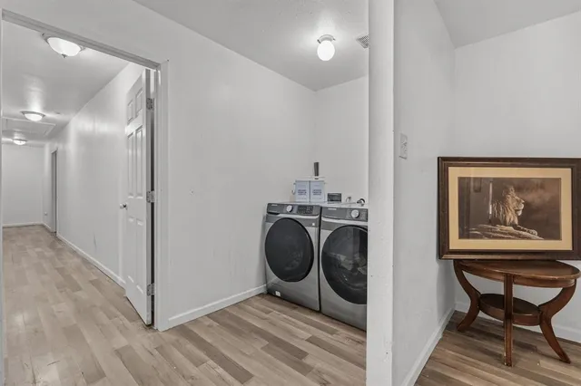 a view of a hallway with washer and dryer