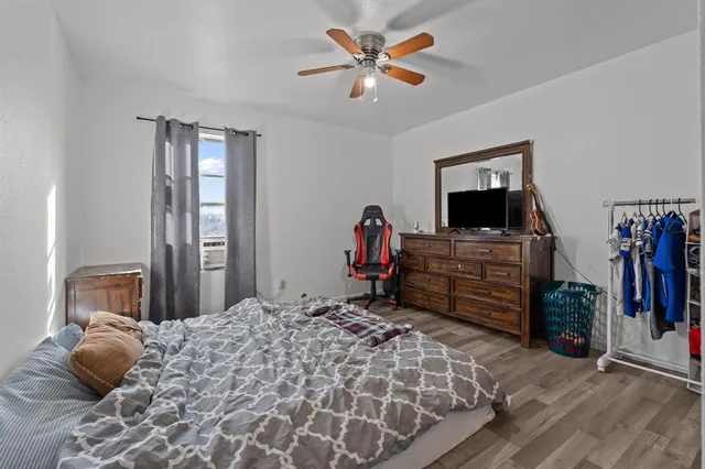 a bedroom with a bed and a television