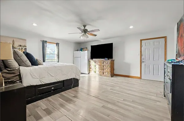 a bed room with a bed and a flat screen tv