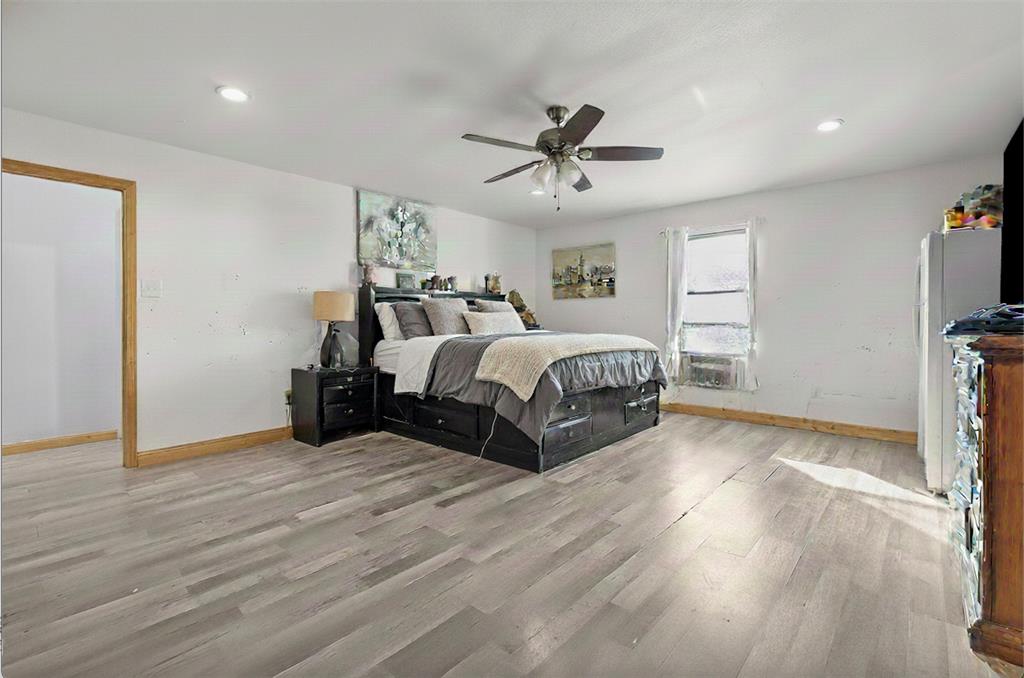 9201 Farmers Road White Settlement, TX 76108 - Photo 19 of 35 a spacious bedroom with a bed and a flat screen tv