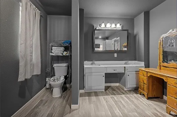 a bathroom with a sink toilet and mirror