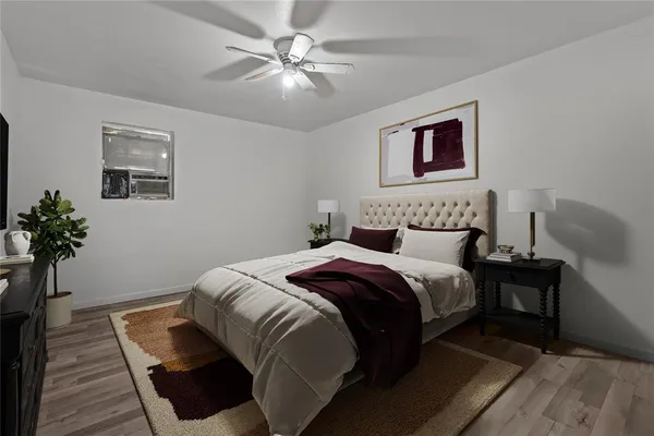 a bedroom with a bed and a potted plant