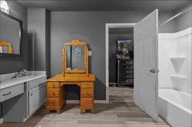 a view of a bathroom with tub and sink