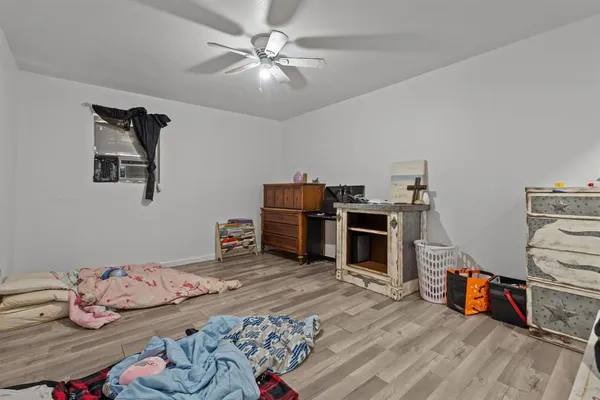 a bedroom with furniture and a wooden floor