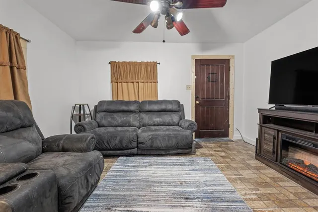 a living room with furniture and a flat screen tv