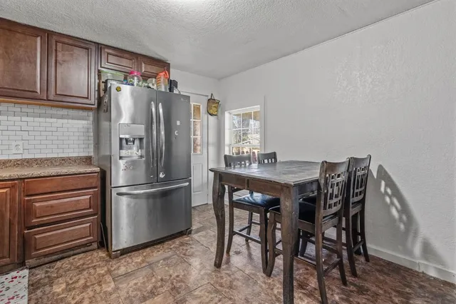 a kitchen with stainless steel appliances a refrigerator and wooden floor