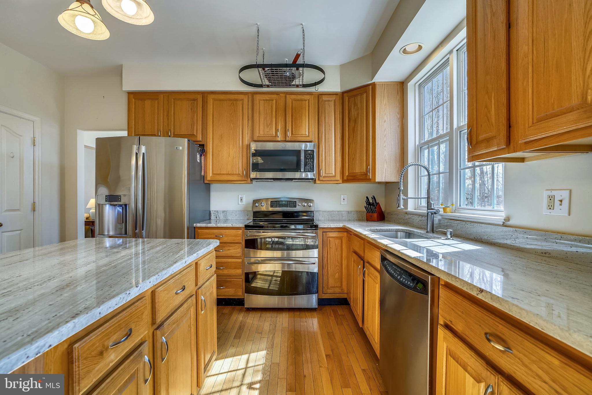 8004 Big Pool Road Laurel, MD 20724 - Photo 7 of 39 a kitchen with stainless steel appliances granite countertop a stove a sink and a refrigerator