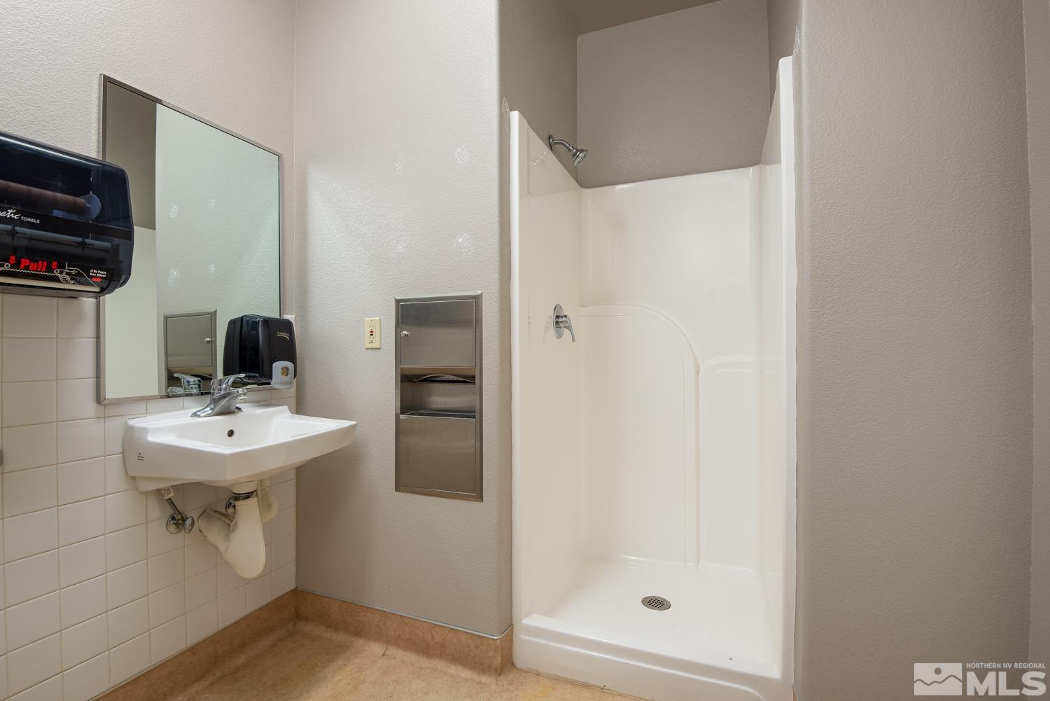5 Pine Cone Road, Unit 102 Dayton, NV 89403 - Photo 16 of 21 a bathroom with a sink a toilet and shower