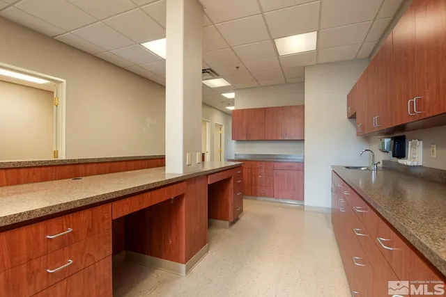 a kitchen with stainless steel appliances granite countertop a sink and a stove