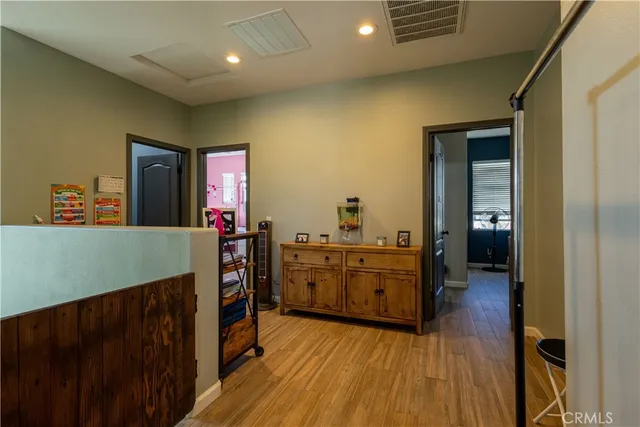 a kitchen view with wooden floor and electronic appliances