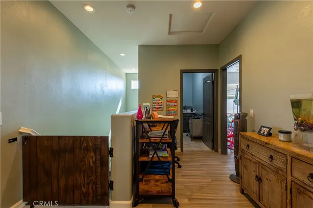 a very nice looking room with wooden floor and furniture