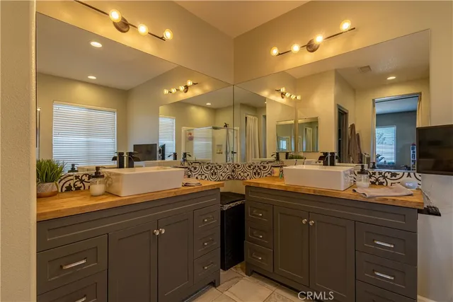 a bathroom with a double vanity sink and a mirror
